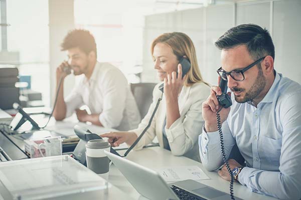 Team of people in an office on the phone to clients