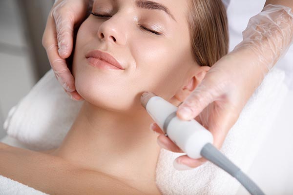 Woman smiling enjoying havign MicroDermabrasion treatment