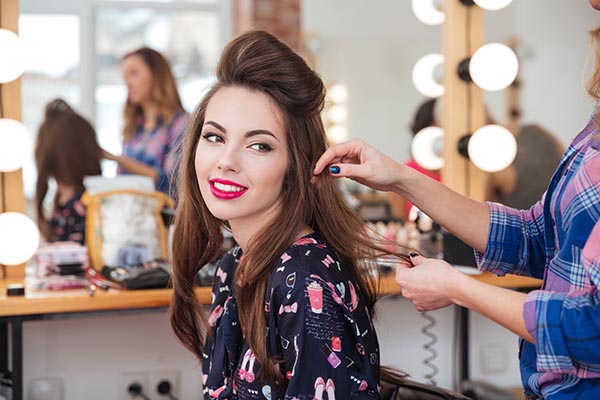 Beauty specialist working in their salon, covered by beauty salon insurance