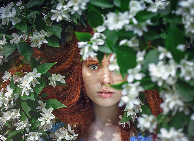 Beautiful woman in artistic view, surrounded by flowers in some sort of fairytale